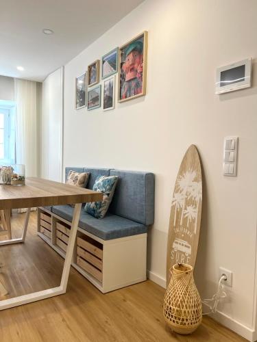 a room with a bench and a surfboard on the wall at Viamar in Viana do Castelo