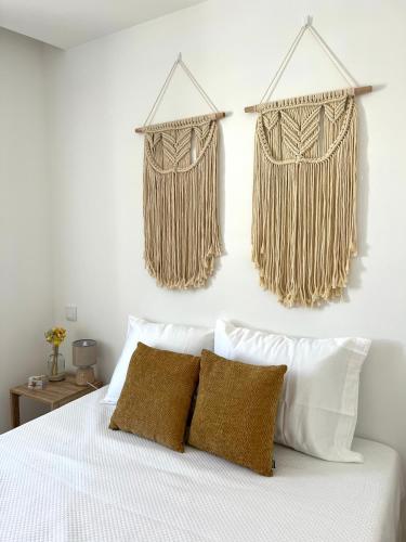 a bedroom with a bed with two hanging curtains at Viamar in Viana do Castelo