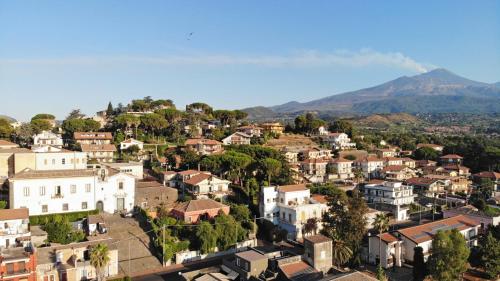 a city with houses and mountains in the background at San Anton Hotel in Trecastagni