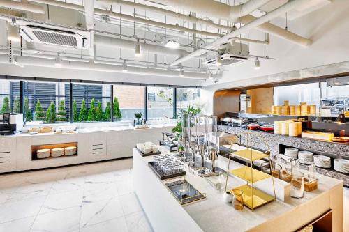 a large kitchen with a counter in a restaurant at Shiftdoor Residence Hari in Busan