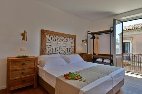 a bedroom with a large bed and a balcony at San Anton Hotel in Trecastagni
