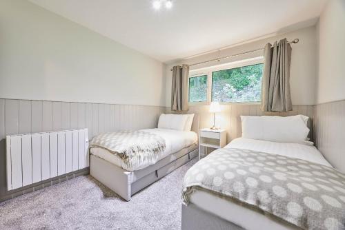 a bedroom with two beds and a window at Host & Stay - Robin's Nest in Gunnislake