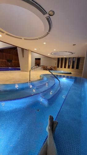 a pool in a hotel with a person laying on the floor at Budapest - Duna part in Budapest