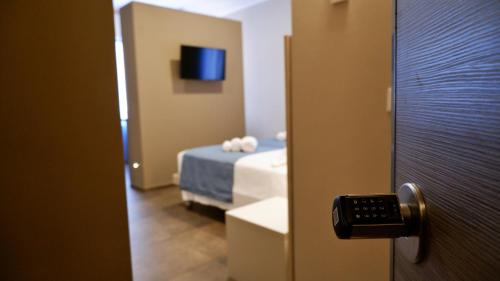 a room with a bedroom with a bed and a tv at Pianomare Riviera Apartments and Rooms in Imperia