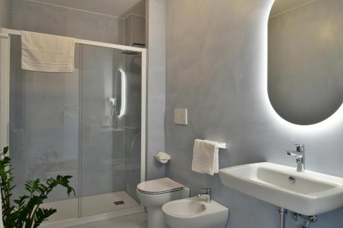 a bathroom with a sink and a toilet and a shower at San Anton Hotel in Trecastagni