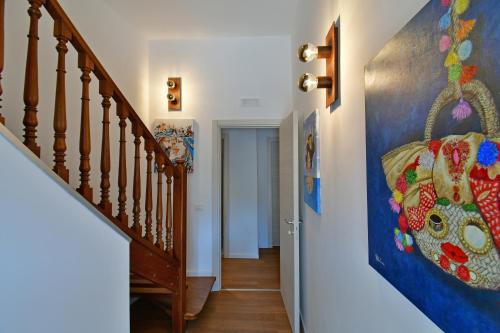 a hallway with stairs and a painting on the wall at San Anton Hotel in Trecastagni