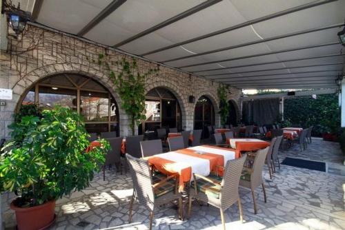 a patio with a table and chairs and a building at Hotel Grbalj in Budva