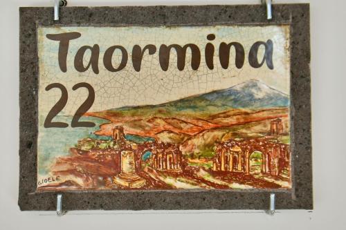 a sign that reads tacoma on a wall at San Anton Hotel in Trecastagni