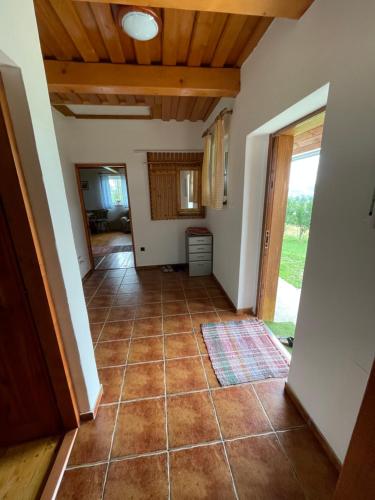 a hallway of a house with a tile floor at Chata Anna in Novoť
