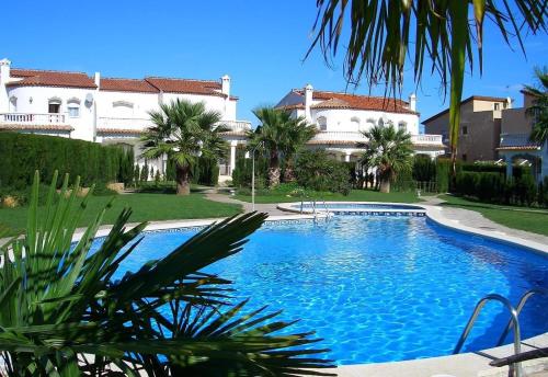 a large swimming pool in front of a house at Casa Luzia in Miami Platja