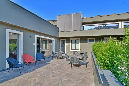 a patio with chairs and tables in front of a house at San Anton Hotel in Trecastagni