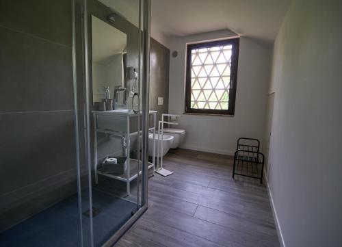 a bathroom with a shower and a sink and a toilet at Casale San Pietro in Palmanova