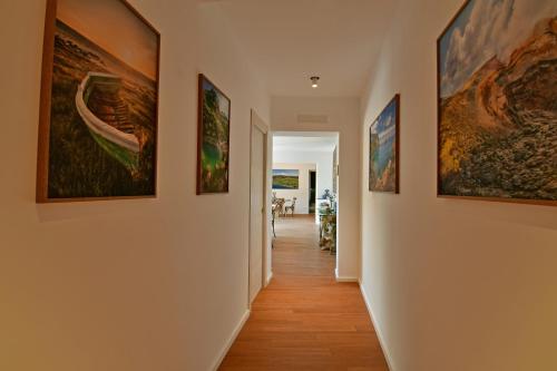 a hallway with paintings on the walls at San Anton Hotel in Trecastagni