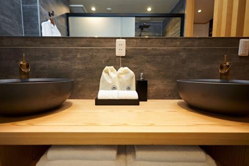 a bathroom with two sinks and towels on a counter at Kumonoue Fuji Hotel - Vacation STAY 13709v in Oishi