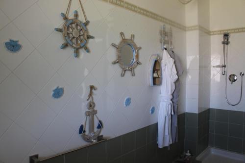 a bathroom with a shower with a mirror and a sink at Halawa Room Giardini Naxos in Giardini Naxos