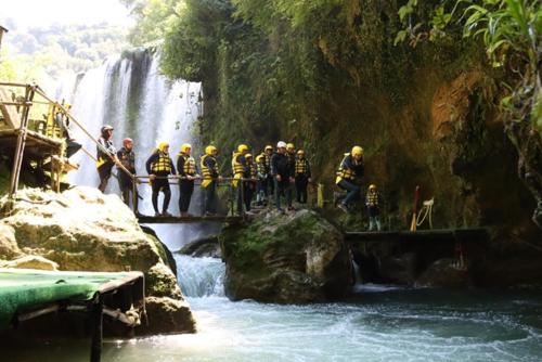 a group of firefighters standing on a bridge over a waterfall at B&B Rox e Claudia in Lugnola