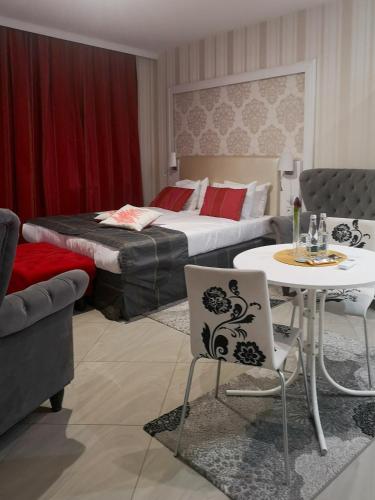 a hotel room with a bed and a table and chairs at Softly Residence in Bydgoszcz