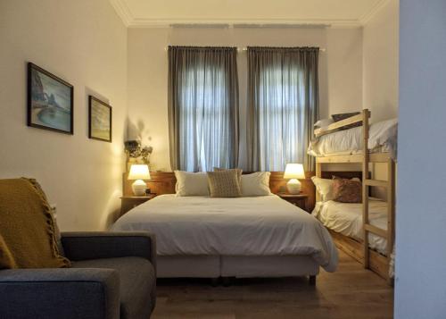 a bedroom with a bed and two bunk beds at Garden Villa Boutique Hotel in Pogradec