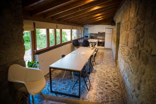 a kitchen with a table and chairs in a room at DreamVille - Casa da Tapada in Arcos de Valdevez