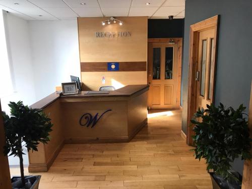 an office with a reception desk and a lobby at Waverley Hotel in Workington
