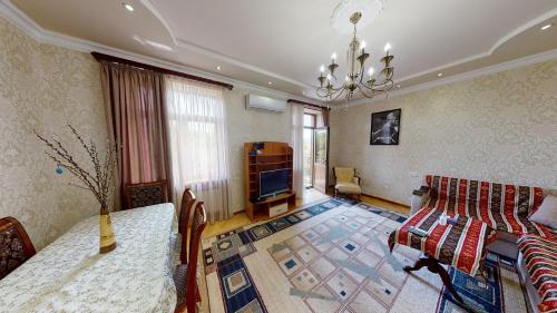 a living room with a couch and a television at Yerevan City Center apartment in Yerevan