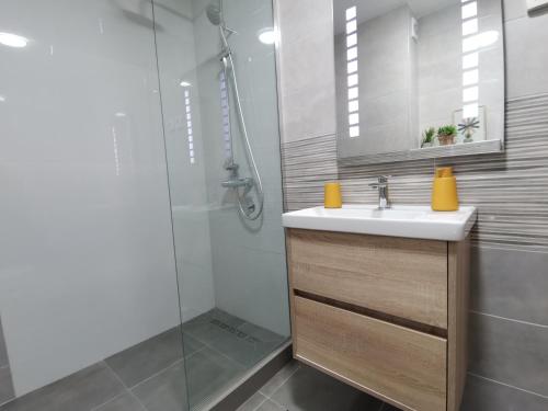 a bathroom with a sink and a shower at Cozy One-Bedroom Apartment at Ljubovic Park in Podgorica