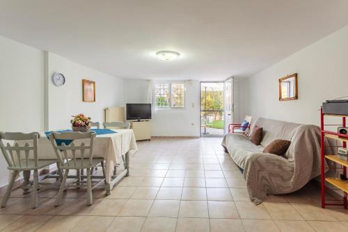 a living room with a table and a couch at Casa Nebari Seaside Retreats - Fully Equipped, Ideal Spot in Petalidhion