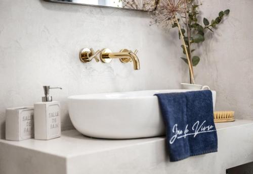 a bathroom with a white sink and a faucet at NEW Design & High Standard Apt from 16th Century in Old Town in Bratislava