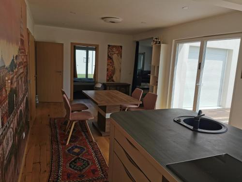 a kitchen and dining room with a table and chairs at Schöne große 90 m² Ferienwohung in Zweikirchen in Zweikirchen