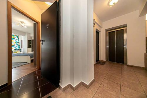 a hallway with a door to a room with a bedroom at Central Studio Bucur in Bucharest
