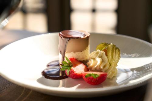 a dessert with chocolate and strawberries on a white plate at Royal Marine Hotel in Brora