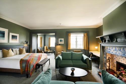 a hotel room with a bed and a fireplace at Royal Marine Hotel in Brora