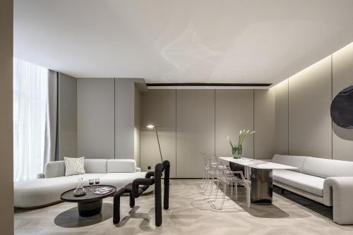 a living room with a couch and a table at Shenzhen ALLIN Space to time in Shenzhen