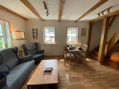 a living room with a couch and a table at Schmallenberger Ferienhaus in Schmallenberg