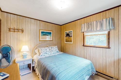 a bedroom with a bed and a window at AVHC23 Beach Box in Avon