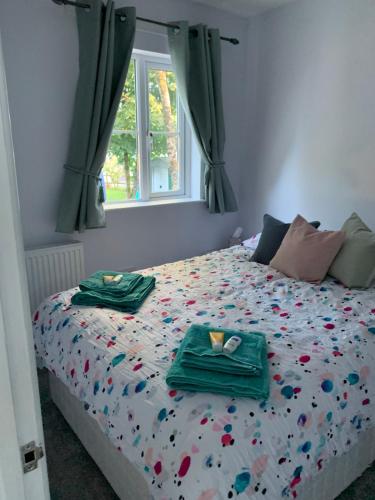a bedroom with a bed with two plates of food on it at Lazy Acres Annex in Langtree