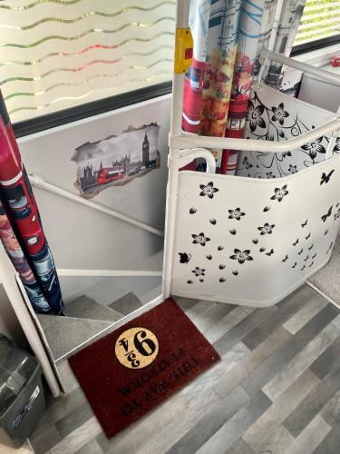 a drawer in a refrigerator with a rug in the floor at Double Decker Bus in Aberystwyth