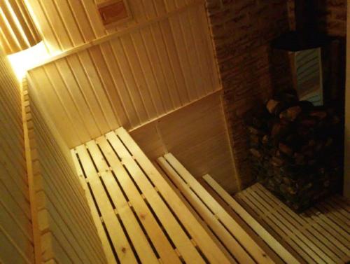 a white bench in a corner of a room at Villa Cheval in Aukštadvaris