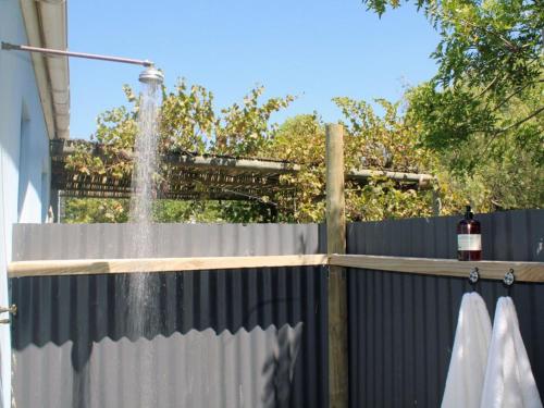 a fence with a water fountain on top of it at The Blue House in Stanford