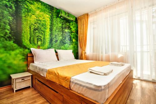a bedroom with a bed with a green wall at ❀ AURORA-AN OASIS IN VIBRANT DOWNTOWN! ❀ A/C, LIFT in Sofia