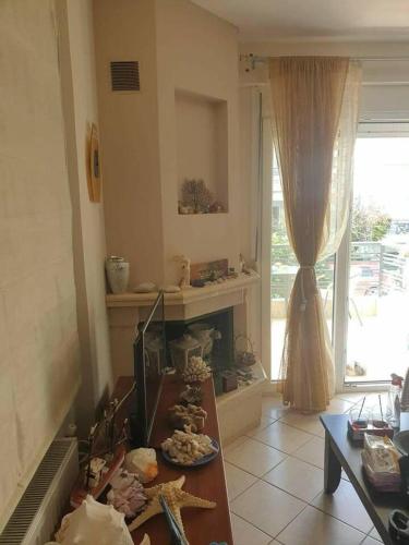 a living room with a table and a fireplace at Dream Nikiti xalkidikis in Nikiti