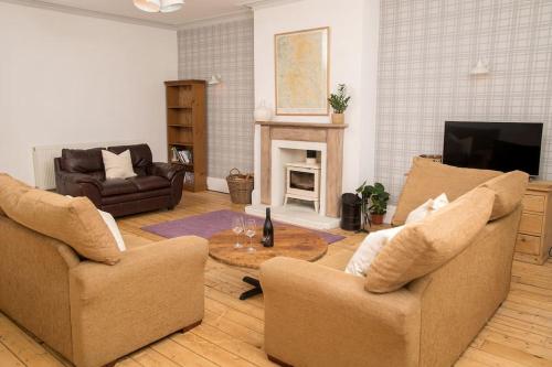 a living room with two chairs and a coffee table at The Cheesery in Chinley