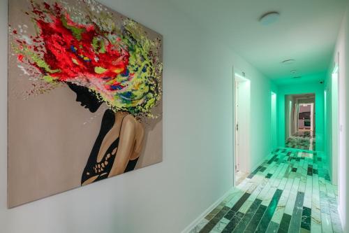 a painting hanging on a wall in a hallway at WOW studios for rent 2 bul Montevideo 25A - B in Sofia
