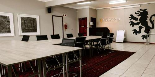 a conference room with a long table and chairs at Ashwood Groenvlei Boutique Hotel in Bloemfontein