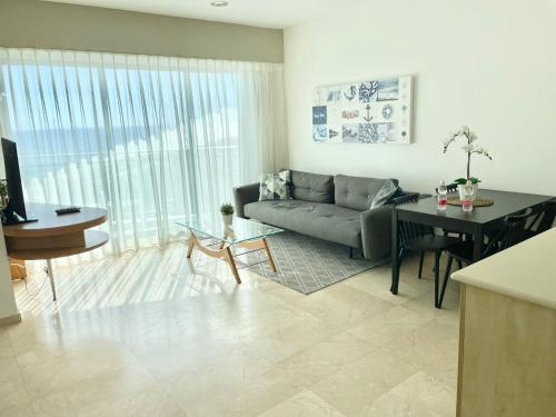 a living room with a couch and a table at Oceanus apartment hotel in Herzliya