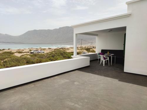 a white house with a view of the ocean at Beach View House in Famara