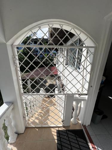 an entry door to a house with a metal gate at Hill Bottom Accommodation in Suva