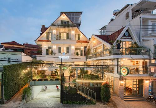 a large white building with lights on it at Le Soleil Boutique Hotel in Da Lat
