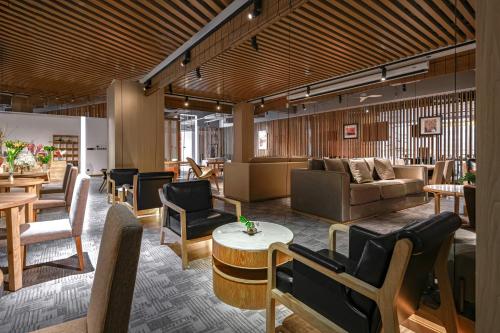 a lobby with couches and chairs and a table at Shenzhen ALLIN Space to time in Shenzhen