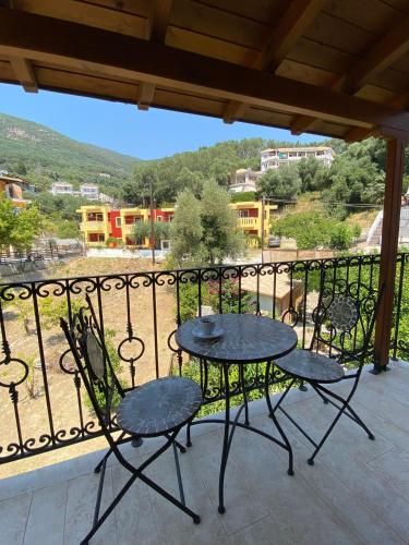 a patio with two chairs and a table on a balcony at Esperides Parga Studios in Parga
